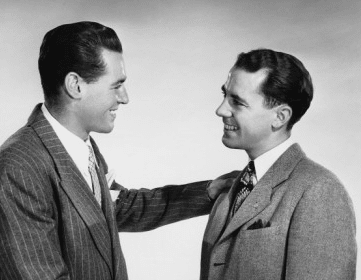A handshake between two men in a black-and-white photo.