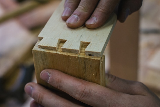 Dovetial joint joining two pieces of wood.