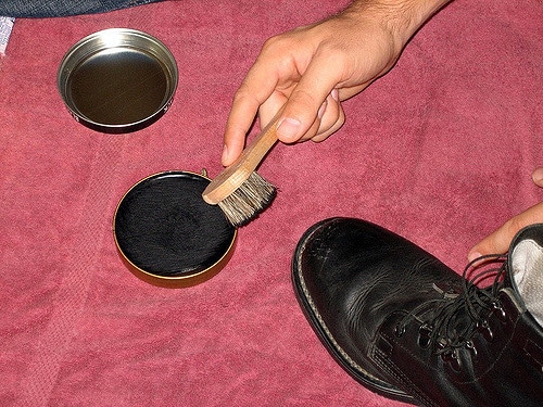 Boot with cherry blossam and brush.