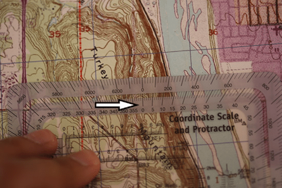 Shooting bearings with protractor on topo topographic map. 