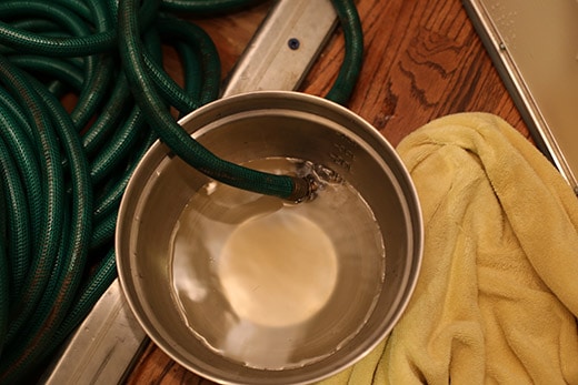 draining hot water heater into bucket 