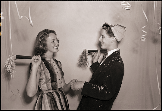 Vintage young boy and girl dancing at birthday party.