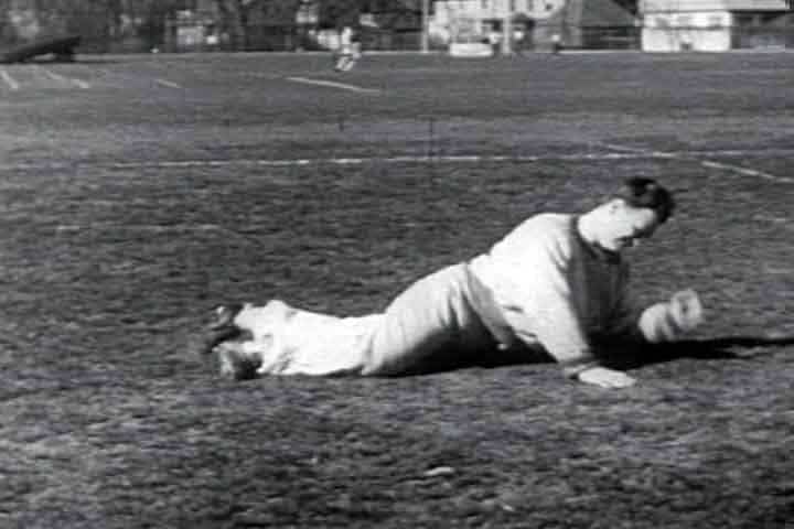 A vintage photograph of a man lying on the ground.