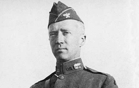 A black and white photo of an officer in uniform.