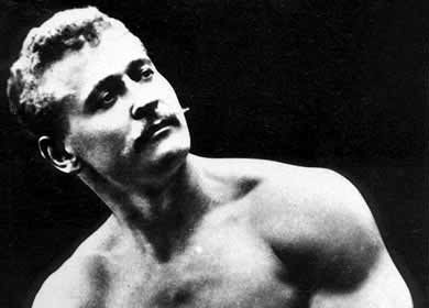 A black and white photo of a man posing, reminiscent of Eugen Sandow, the strongman.