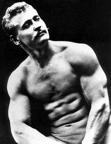 A black and white photo of a man posing, reminiscent of Eugen Sandow, the strongman.