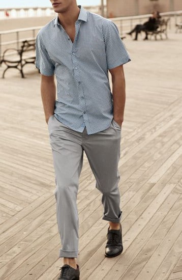 Man wearing a lining shirt posing while walking.