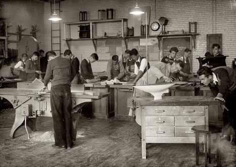 A group of high school students honing their skills in a wood shop.