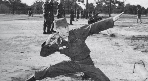 Vintage soldier boot camp basic training throwing shot put.