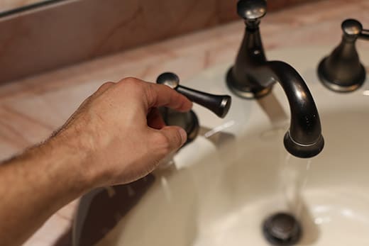turning on hot water faucet 