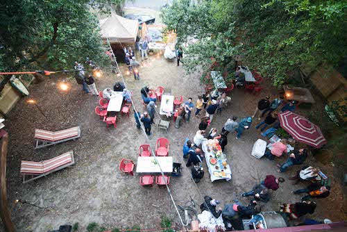 People enjoying dinner party with pig meat.