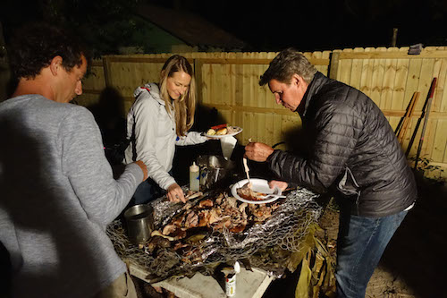 People are enjoying the roasted pig meat.