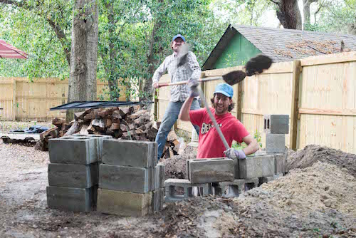 Men using cinder blocks to keep our dogs from rummaging.