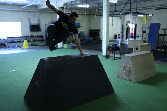 man vaulting jumping over concrete barrier movnat workshop