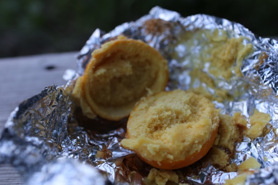 Orange peel cupcake in tin foil campfire dessert.