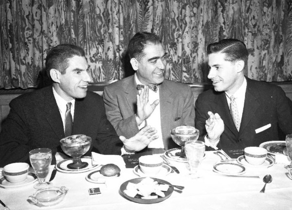 Men at dinner fighting over the bill vintage photo.