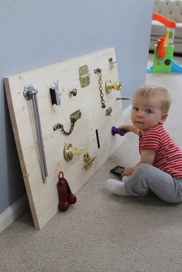 Child Playing with DIY Toddler Activity Board.