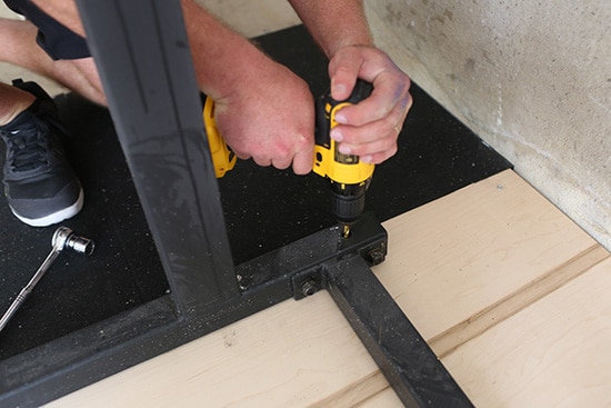 Man bolting Rack to the Platform.