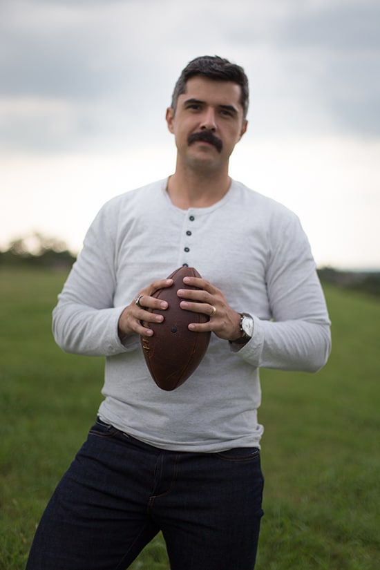 Man holding american football.