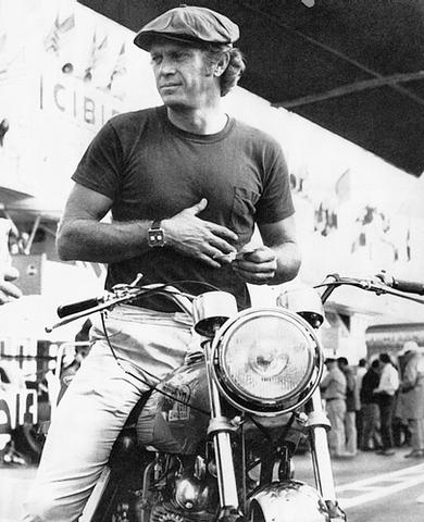 Vintage motorcycle wearing racing watch on wrist. 