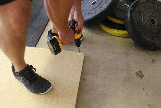 Men Screwing Particle Board Together.