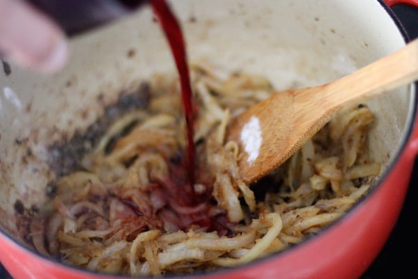 Homemade beef stroganoff stirring in red wine.