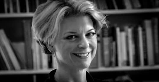 A black and white photo of Frances smiling.