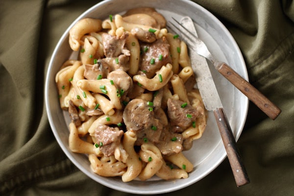 A bowl of Beef Stroganoff pasta with meat and mushrooms.