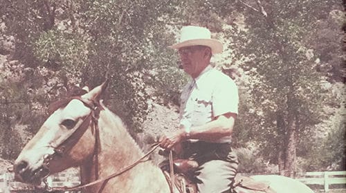 An elderly man on a horse.