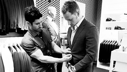 A man is upgrading a suit in a store.