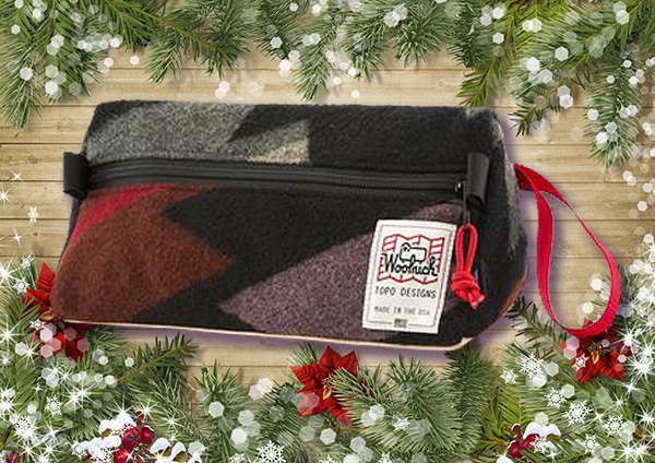 Topo designs dopp kit with decorated background.