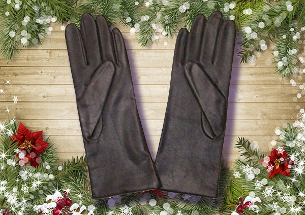 A beautiful pair of fownes leather gloves on the table.