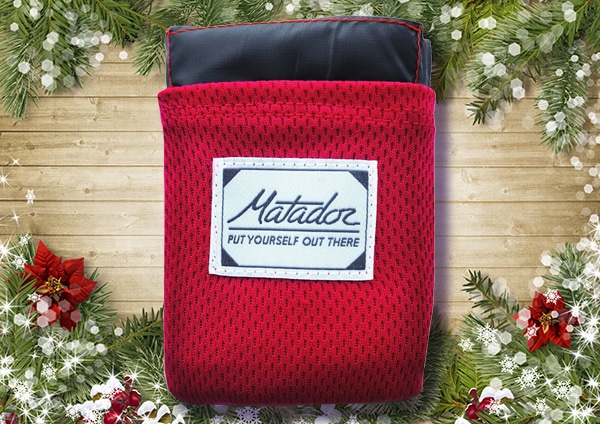 Matador pocket blanket with cover for women.
