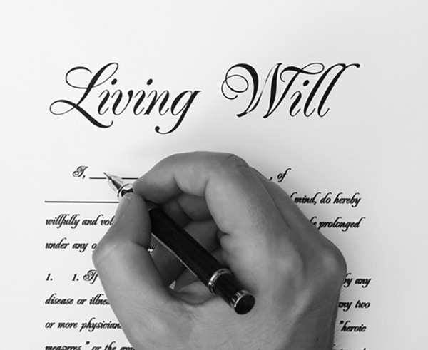 Man filling out living will document.