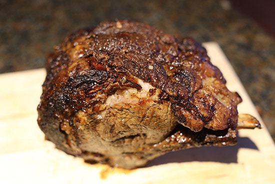 Cooked prime rib roast on cutting board.