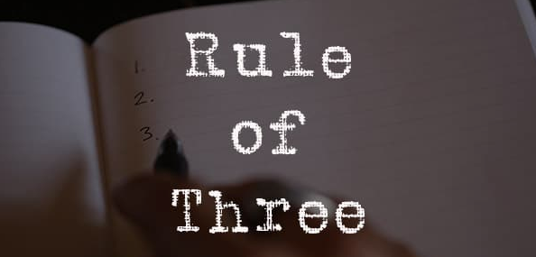 A person writing in a notebook with the phrase "Rule of 3" to optimize their productivity.