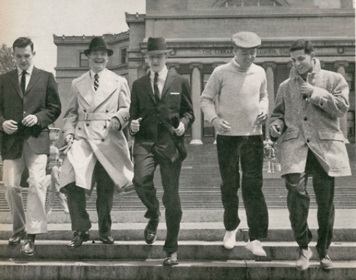 A group of men in suits walking down steps.