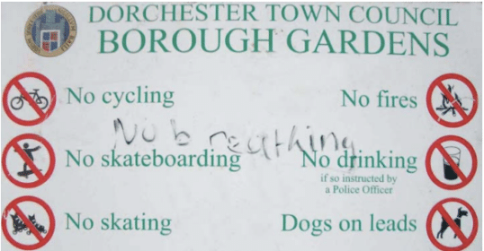 Sign in Dorchester town council's borough gardens, warning of risks for kids.