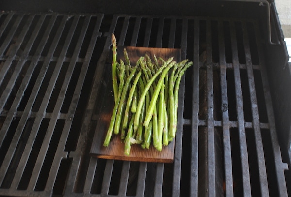 Asparagus on wood grilling plank.