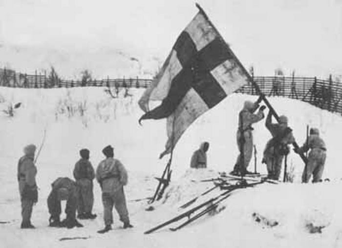 Finnish soldiers raising finland flag wwii.