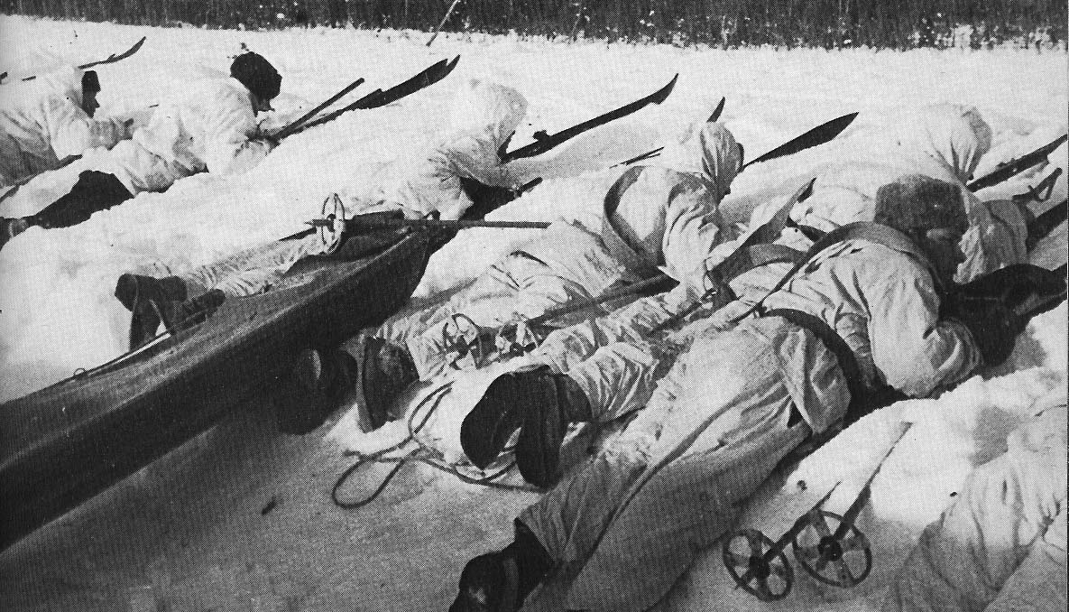 Finnish soldiers lying down in snow aiming rifles wwii.