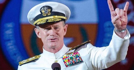 A man in a navy uniform making a hand gesture, possibly from the Podcast.