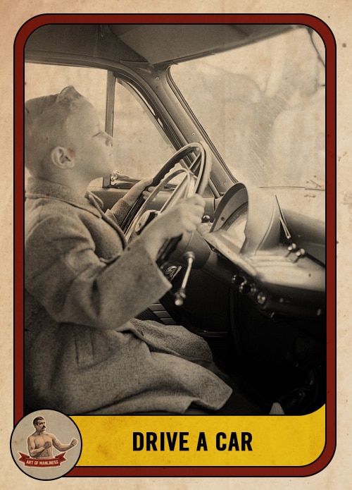 Vintage boy at the steering wheel of a car driving.