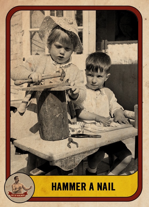 Vintage young kid using a hammer to pound a nail.