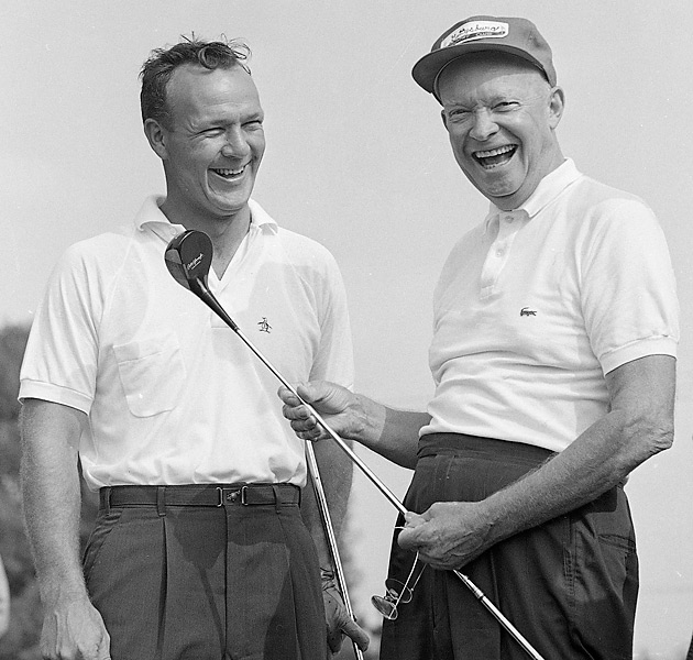 Dwight eisenhower playing golf wearing polo and baseball cap while smiling.
