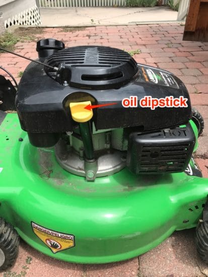 How to locate the oil dipstick on a lawnmower.