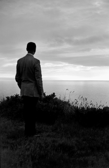 Vintage man staring out over the ocean.