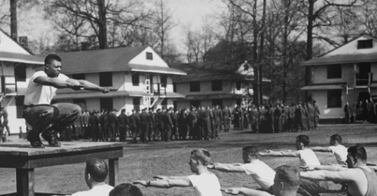A vintage black and white photo of men staying fit through exercises.