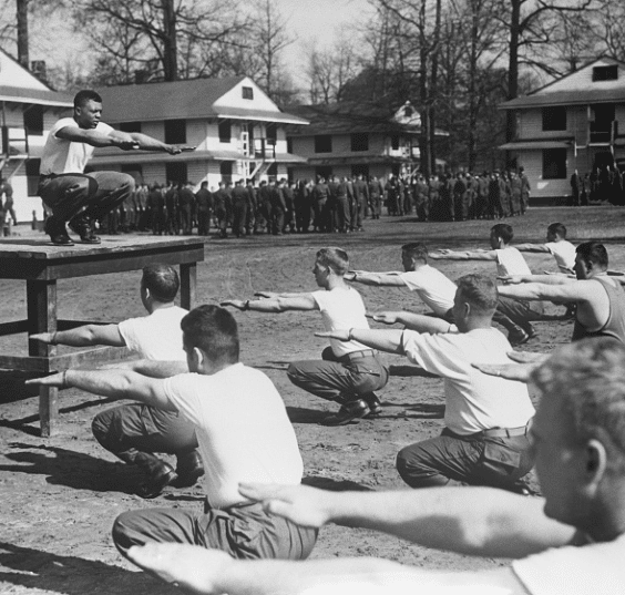 A vintage black and white photo of men staying fit through exercises.