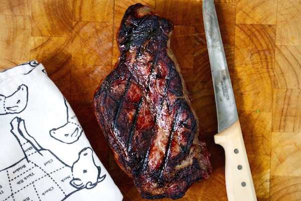 Grilled steak on wooden cutting board. 